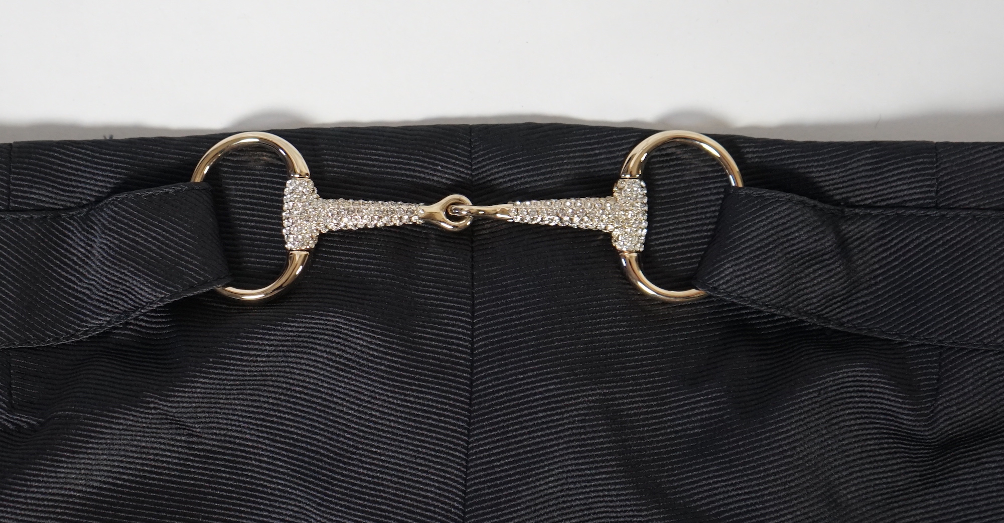 A pair of Gucci lady's textured satin trousers with gold tone diamante snaffle detail to the back and a Gucci velvet blouse, Gucci trousers: size 40, blouse size 44